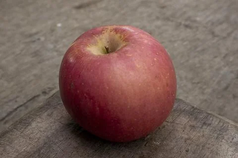 A red apple held by a man's hand Photos