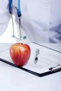A Red Apple Lying on the Doctor's Table Fotos Stock