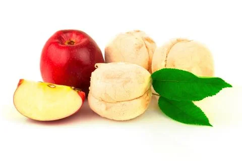 Red apple, marshmallows, slices and green leaves Stock Photos