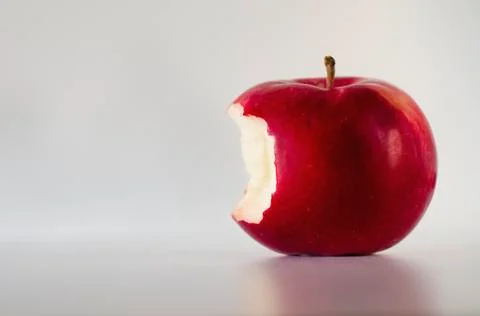 Red apple with missing bite, studio shot Stock Photos