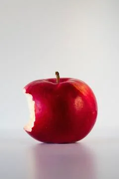 Red apple with missing bite, studio shot Stock Photos