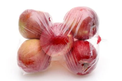 Red apple in a plastic bag Stock Photos