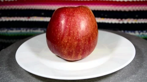 Red apple on a plate Video stock 143153373