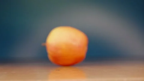The red apple rolling on the wooden table in Estonia Stock Footage 245286103