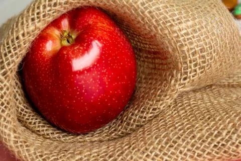 Red apple sackcloth on background Stock Photos