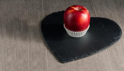 Red apple simulating chocolates on blackboard Stock Photos