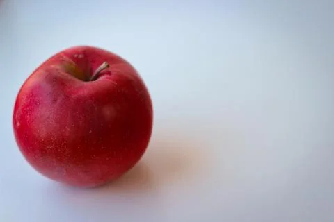 Red apple stand on a white surface Stock Photos
