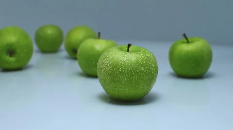 Red apple standing out from large group of green apples. Horizontal shape Видео 48150412