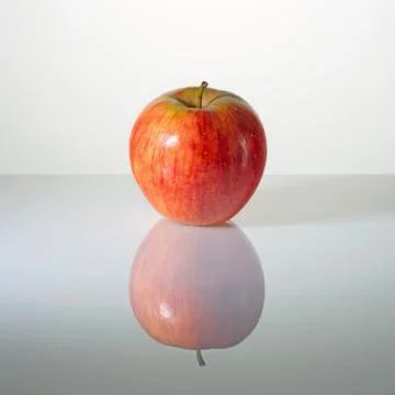 Red apple on a surface with reflection Stock Photos