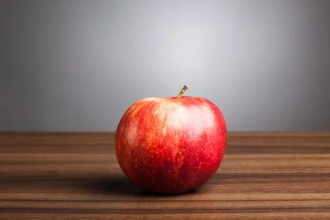 Red apple  on table, gray background Stock Photos