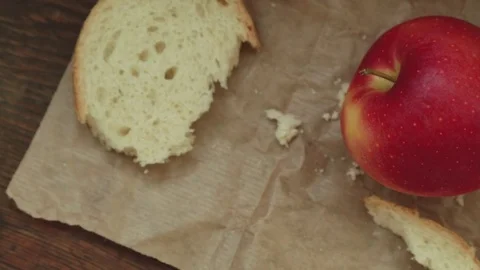 Red apple on vintage paper with bread crumbs Stock Footage 80350803
