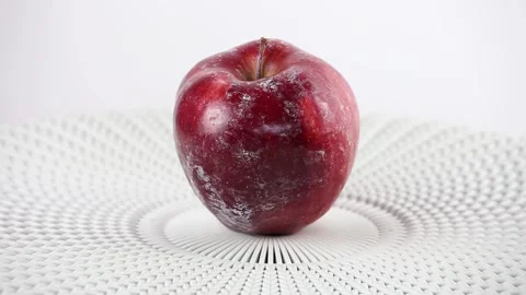 Red apple with white layer of protection wax partially dissolving. Video stock 152831228