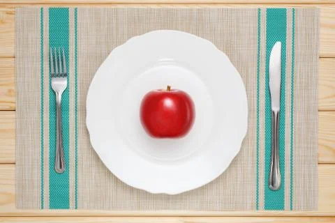Red apple on a white plate Stock Photos