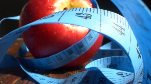 Red apple wrapped with measuring tape. Diet, healthy eating, weight loss concept Stock Footage 154309364