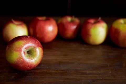 Red apples on a brown table. Close-up. Stock Photos