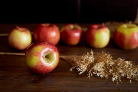 Red apples on a brown table. Close-up. Stock Photos