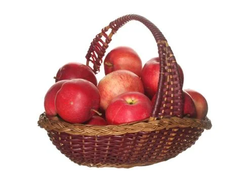 Red apples in a decorative fruit basket isolated on white background. Stock Photos