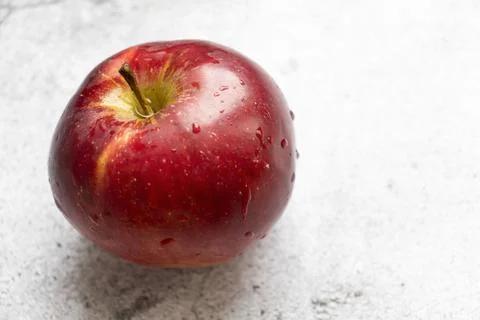 Red apples on a gray background. Stock Photos