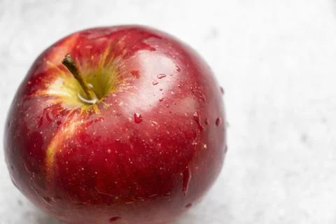 Red apples on a gray background. Stock Photos