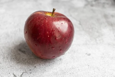 Red apples on a gray background. Stock Photos