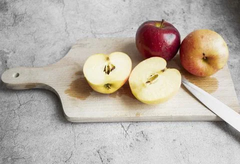 Red apples on a gray background. Stock Photos