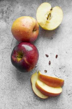 Red apples on a gray background. Stock Photos