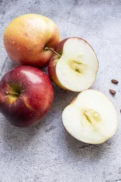 Red apples on a gray background. Stock Photos
