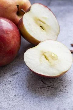Red apples on a gray background. Stock Photos