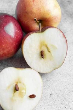 Red apples on a gray background. Stock Photos