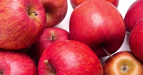 Red apples lined up against a white background. Video stock 231098703