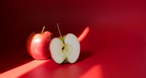 Red apples on a red background. Flat lay, copy space Stock Photos