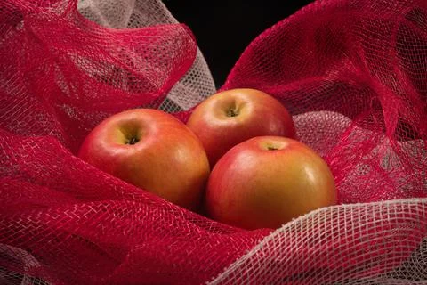 Red apples on a red background Stock Photos