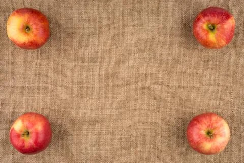 Red apples on sackcloth. Stock Photos