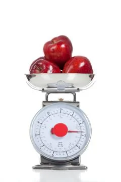 Red apples on a scale on white Stock Photos