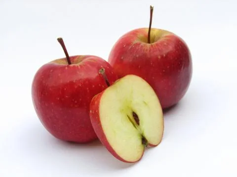 Red apples with a slice on white background Fotos de archivo