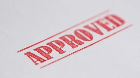 Red approved stamp being placed on white paper document in close up cinemat.. Stock Footage 334641452