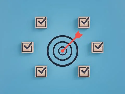 Red arrow hitting the center of a target surrounded by wooden blocks Stock Photos