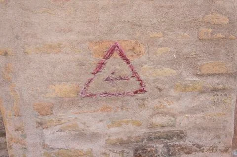 Red arrow painted in a wall background Stock Photos