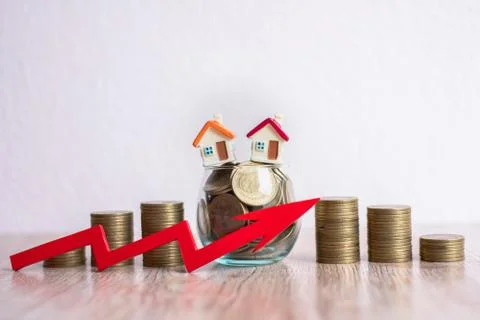 The red arrow is placed in front of the pile of coins. A coin in a glass bott Stock Photos