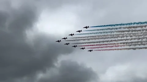 Red Arrows stream red, white and blue trails on the RAF Centenary flypast. Stock Footage 131978205