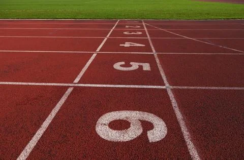 Red athletic track treadmill at the stadium with the numbering. Stock-Fotos