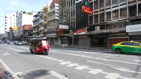 Red Auto Rickshaw Driving Through Urban Street in Bangkok Thailand Stock Footage 338424898