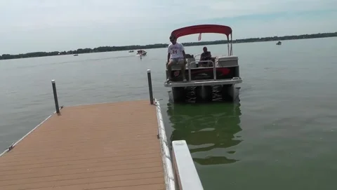 Red Awning Pontoon Boat Docks with 3 People Stock Footage 201110497