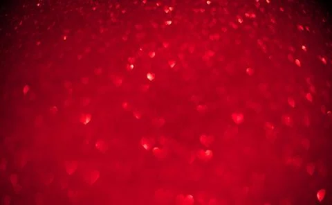 Red background of blurred hearts, side of defocus Stock Photos