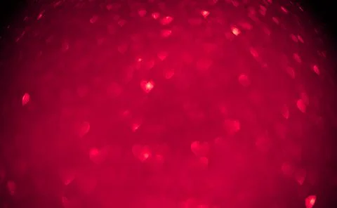 Red background of blurred hearts, side of defocus Stock Photos