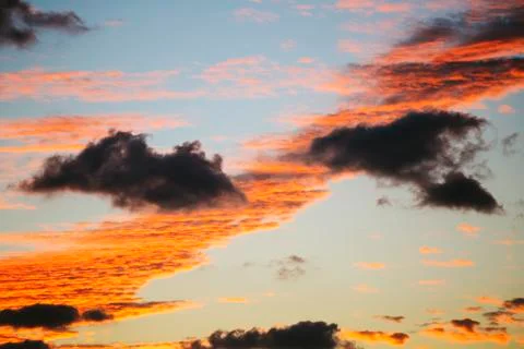 Red background with clouds . Sky with clouds 库存照片