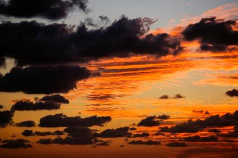 Red background with clouds . Sky with clouds Stock Photos