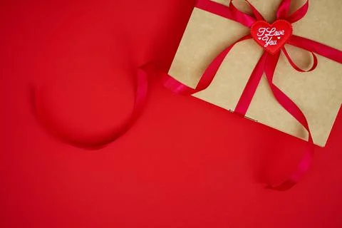On red background craft box with satin ribbon Stock Photos