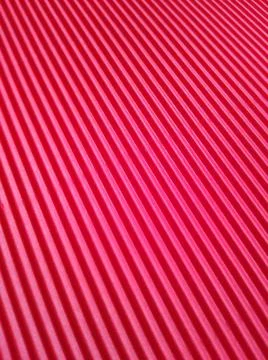 Red background with parallel stripes at different angles 库存照片