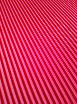 Red background with parallel stripes at different angles 写真素材
